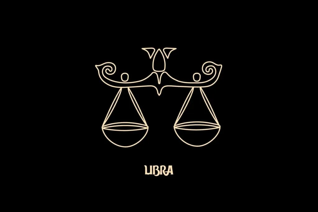 Ilustração em estilo de arte de linha bege sobre um fundo preto, representando o signo astrológico de Libra. A imagem retrata uma balança ornamentada e equilibrada, com detalhes em curvas nas extremidades superiores. Abaixo do desenho, está escrita a palavra "LIBRA" em uma fonte estilizada.