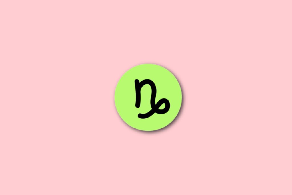 círculo verde com ilustração preta do símbolo do signo de capricórnio sobre fundo rosa