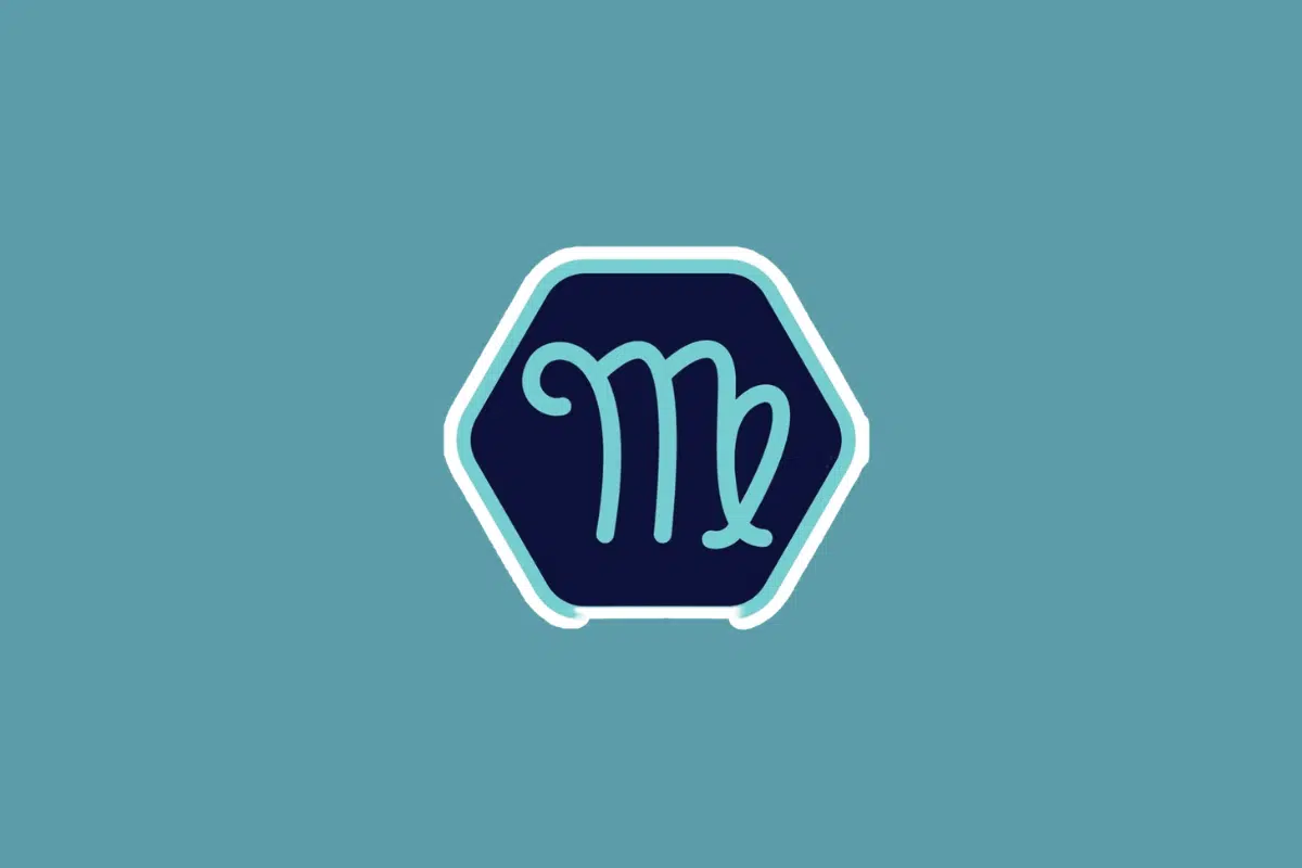 Ilustração minimalista do símbolo do signo de virgem em tom azul-claro, centralizada dentro de um hexágono azul-escuro com borda branca e azul. O fundo da imagem é em um tom sólido de azul-turquesa